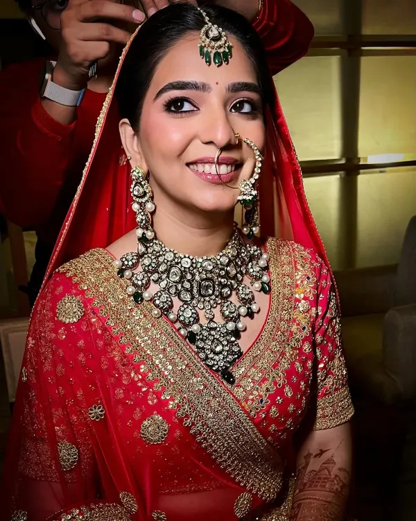 A radiant smile on my beautiful bride Sanya. Her look was centered around deep kohl-rimmed eyes and semi-matte skin to perfectly complement her stunning red and gold lehenga.