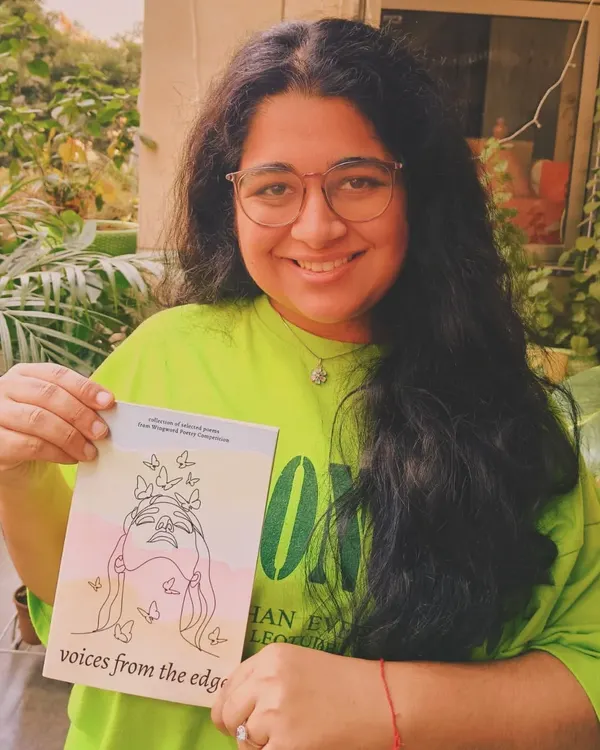 A published poet from our competition, beaming with her copy of the anthology 'voices from the edge'. This is the moment we work for.