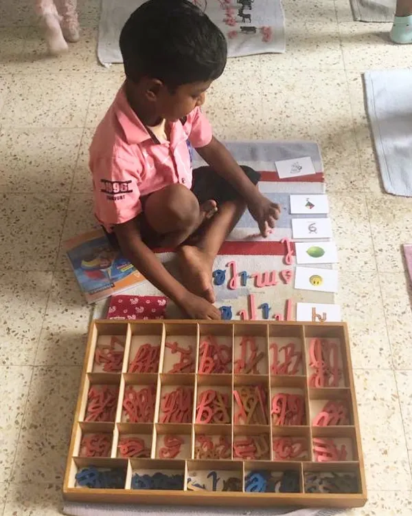 The Moveable Alphabet is where children first experience the magic of writing. They use these wooden letters to build words and sentences, expressing their own thoughts long before their hands are ready to hold a pencil perfectly.