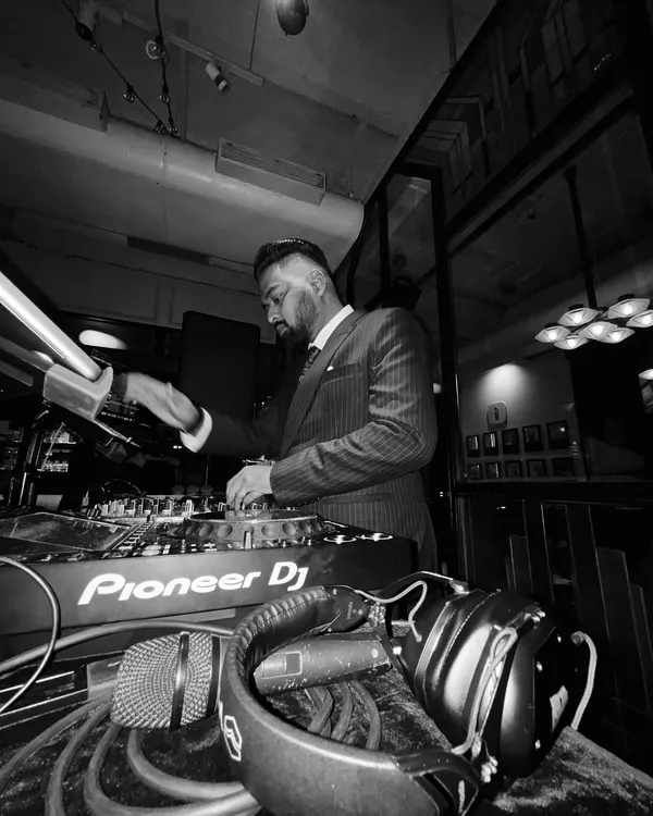 A black and white shot of me in a suit, focused on the mixer. This captures the classic, timeless feel I can bring to a formal event.