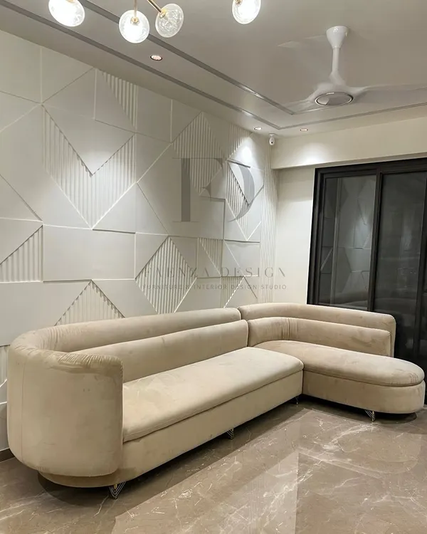 This L-shaped sectional in a soft cream fabric offers a clean, modern aesthetic. Its curved corner and chaise lounge provide ample, comfortable seating, making it a perfect fit for contemporary living rooms.