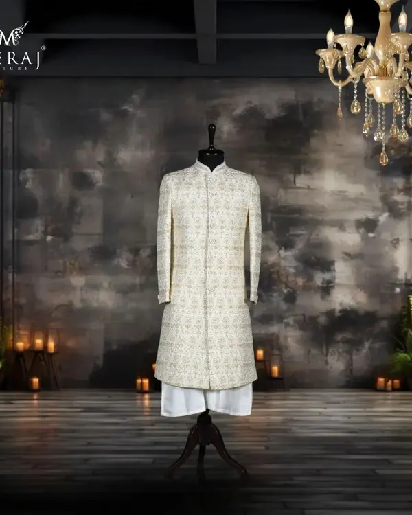 This off-white silk sherwani is a masterpiece of understated luxury. The entire surface is adorned with intricate Poth Zardozi detailing, creating a rich texture that is both classic and sophisticated.