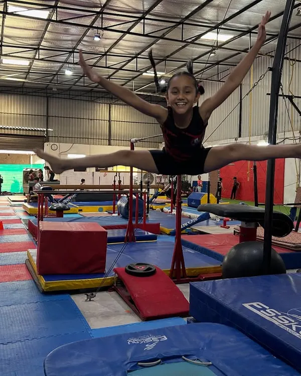 This is what it's all about. The hard work, the discipline, and then the pure joy of flight. Here, one of my young gymnasts executes a perfect split leap, showing the power and grace we build at the academy.