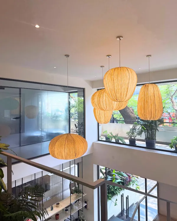 This is the view from the top floor of our Indiranagar cafe. I love how the natural light hits the woven pendant lamps and the greenery. It’s a perfect example of the Pinterest-worthy, Japandi aesthetic I was going for.