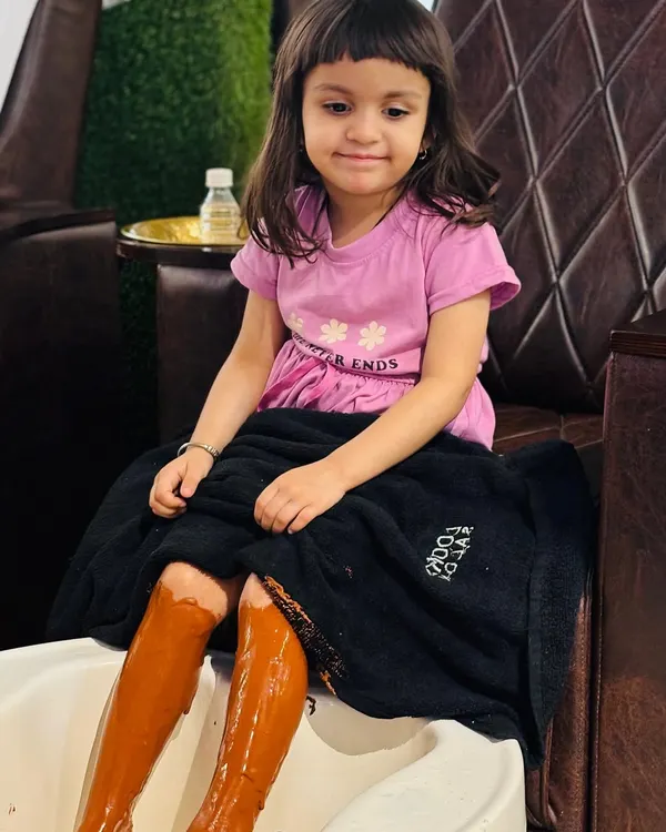 Pampering is for everyone, even our youngest clients. Here's a little one enjoying our special Pedi Café treatment, which uses a gentle, coffee-based formula that smells amazing and leaves skin feeling super soft.