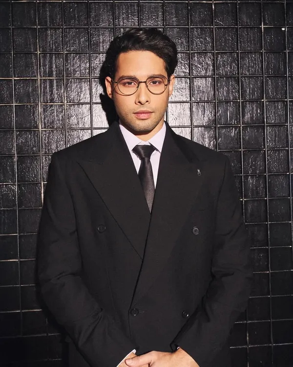 A close-up of Siddhant Chaturvedi in a custom double-breasted suit by Zafir and Shadab. The sharp tailoring, crisp white shirt, and classic tie create a powerful and sophisticated look.
