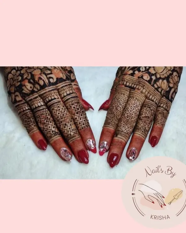 A beautiful bridal nail set featuring a classic red polish and accent nails with encapsulated silver glitter to match the wedding attire.