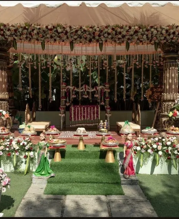 This stunning outdoor muhurtham mandap combines traditional architecture with an abundance of fresh flowers for a magical ceremony setting.