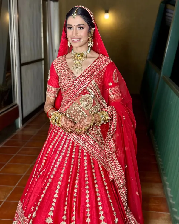 The quintessential Indian bride, radiant in a classic red lehenga. I focused on creating a luminous base and soft, defined eyes to let her natural beauty and the richness of her outfit shine.