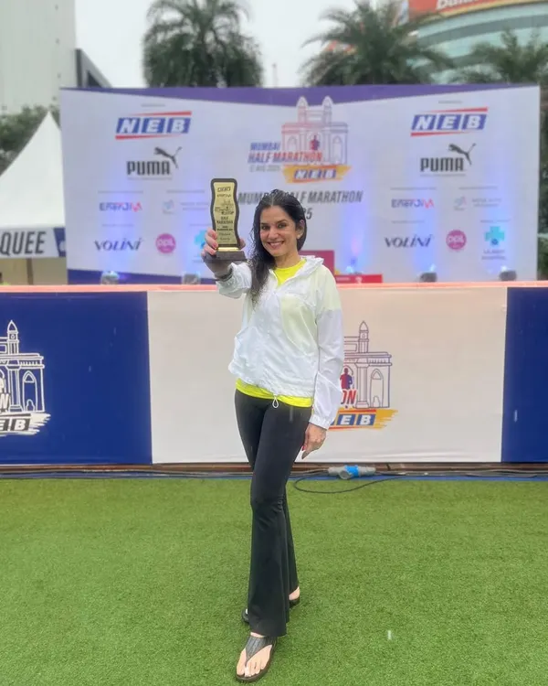 Celebrating Dr. Indu Tandon's 3rd place finish in the Women's Open Category at the Mumbai Half Marathon. A proud moment holding the trophy that represents all the hard work.