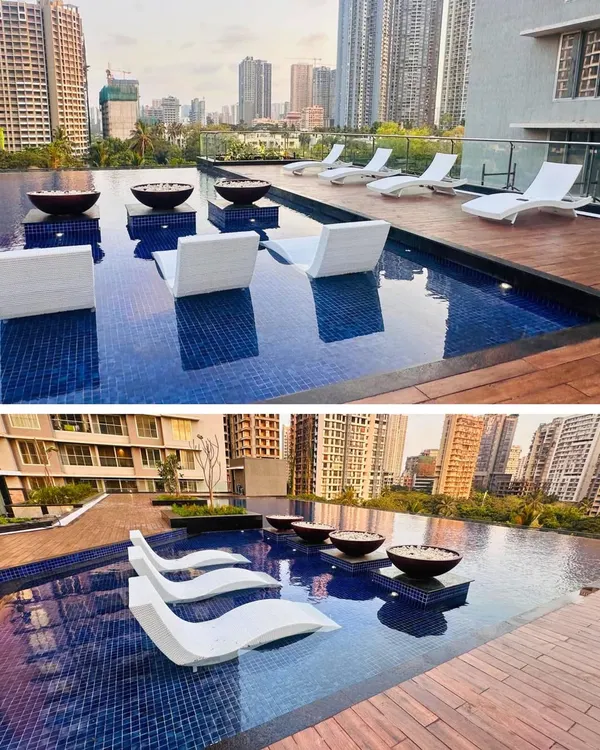 The rooftop pool at Ekta Tripolis in Goregaon, Mumbai. We designed this space to be a true urban escape, with in-water lounge chairs and a stunning view of the city skyline, offering residents a resort-like experience at home.