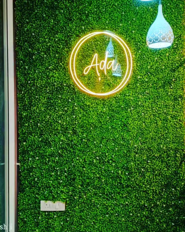 This is a custom green wall I created for a retail store, featuring their brand logo in neon. This is an effective way to create a branded photo opportunity for customers.