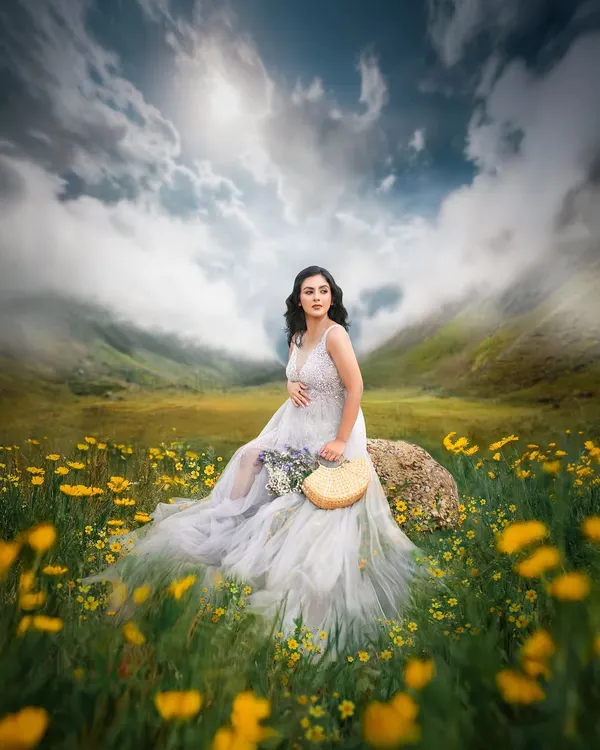 This is the essence of a fairytale maternity shoot. I create these magical, dreamlike scenes outdoors, using styling and editing to bring a vision to life in a field of flowers under a dramatic sky.