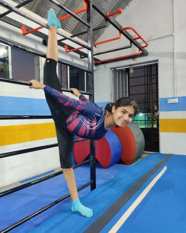 Passion stretches the limits. This gymnast demonstrates incredible flexibility with a standing split, a skill that takes hours of dedicated practice to perfect.