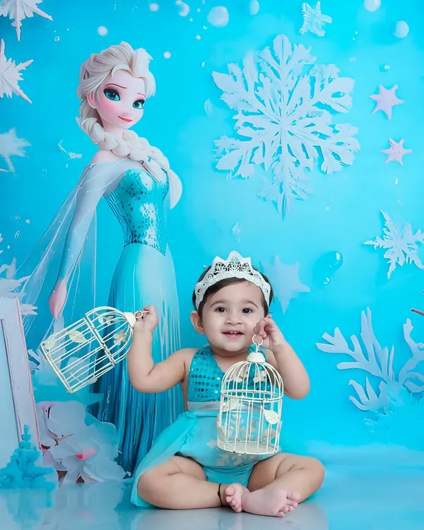 Welcome to Arendelle. Dressed as a little snow queen with her crown, this baby is ready for a magical adventure in our Frozen-themed winter wonderland.