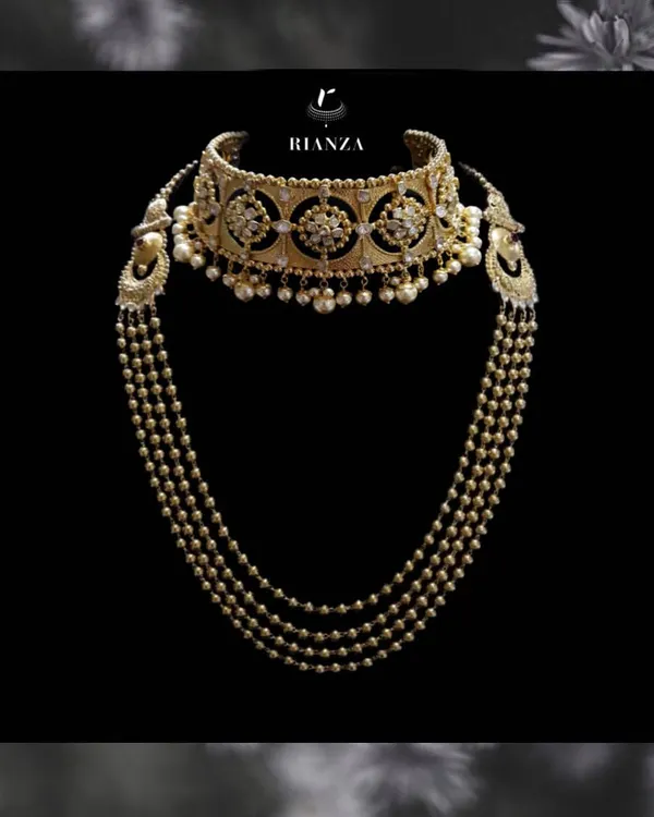 A complete Rajwadi bridal set. This features a wide kundan and pearl choker with a matching multi-string pearl and gold bead necklace, designed to be worn together for the main ceremony.