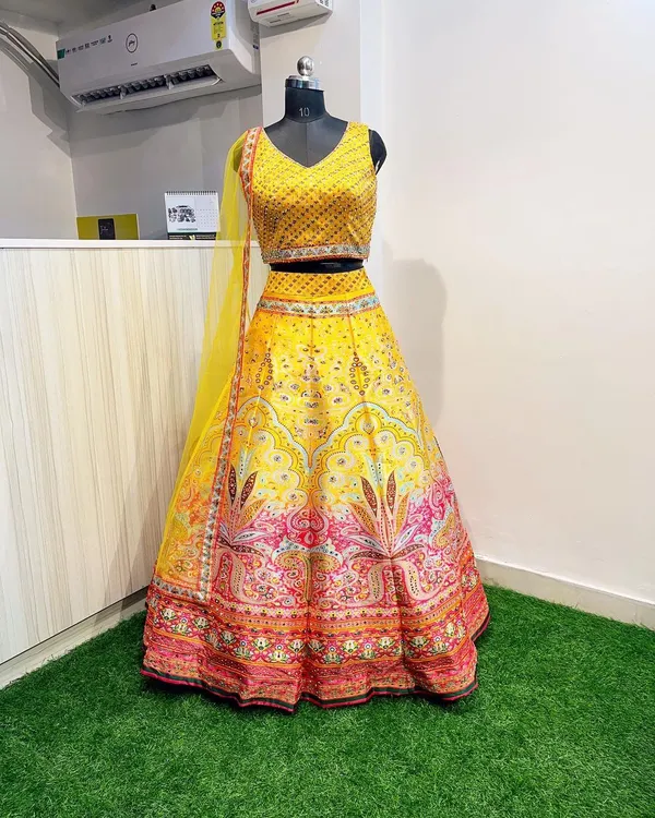 A full view of my popular Haldi lehenga, showcasing the contrast between the sequined yellow blouse and the colorful printed skirt. It's a complete, ready-to-wear look for any pre-wedding celebration.