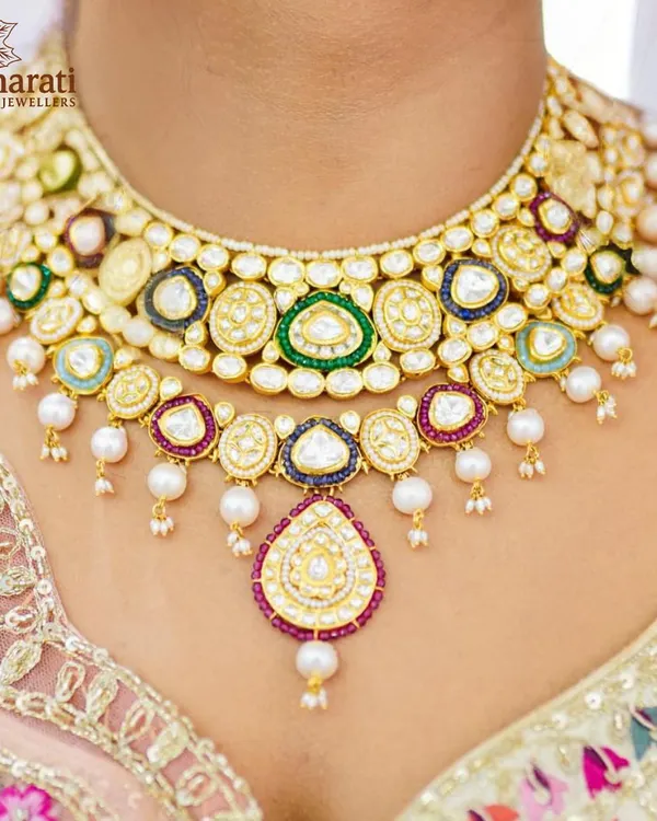 A masterpiece for your most cherished day. This bridal necklace, resplendent with multi-hued Kundan and delicate pearls, is crafted to make you feel like royalty. It sits gracefully, capturing the light and the attention of all who behold it.