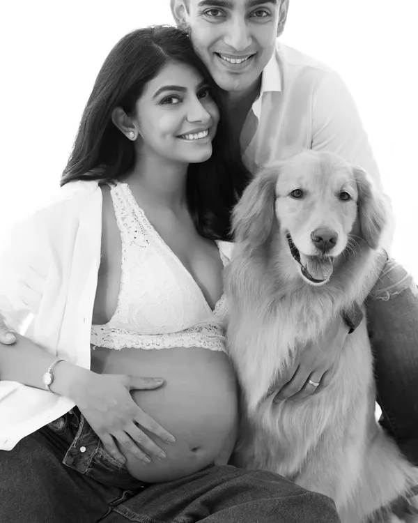 A powerful black and white family portrait. Removing the color focuses the viewer's attention on the love and connection between the couple and their dog.