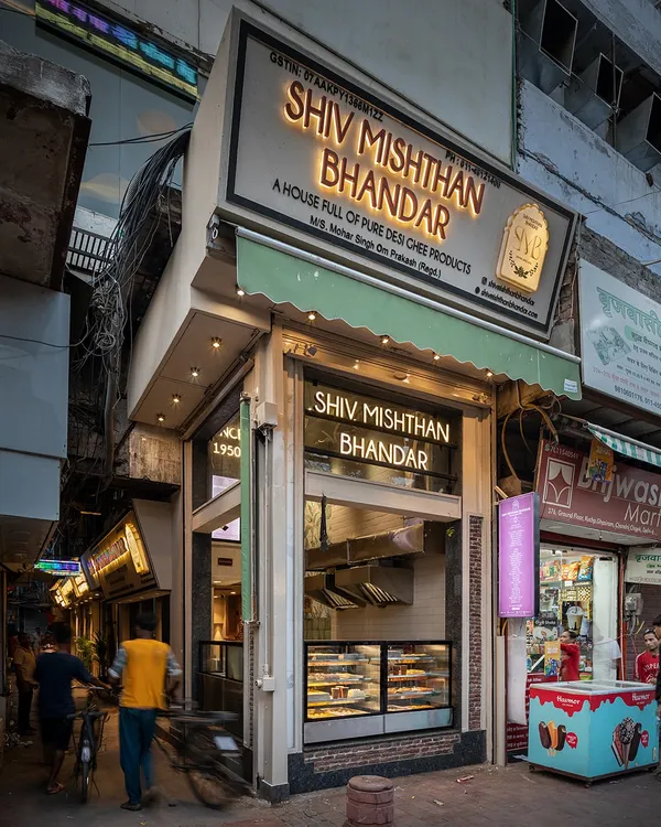 The exterior of Shiv Mishthan Bhandar in Chandni Chowk. The renovated facade uses materials like red stone and lakhori bricks, inspired by the architecture of old havelis, to blend seamlessly into its historic context.