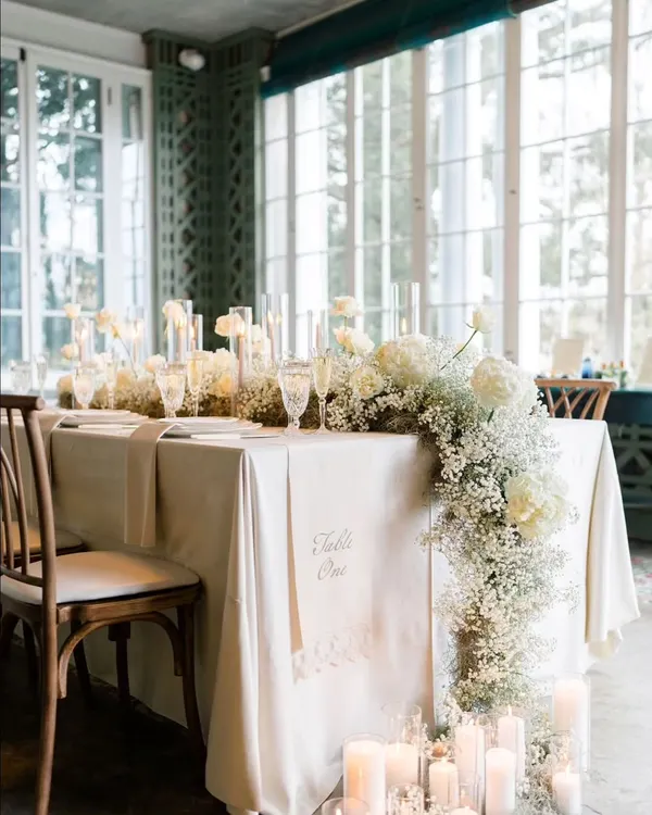 My basics are clear, no basic please. This elegant tablescape with a cascading baby's breath runner, candles, and fine tableware is the standard of sophistication I bring to my events.
