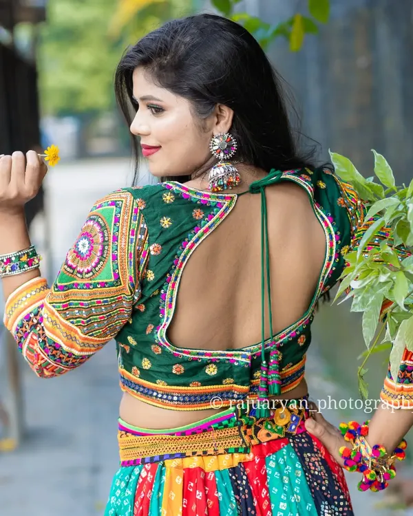 Dandiya and Garba season is here. My handmade chaniya cholis have a full gher (flare) perfect for twirling. This multi-colored outfit with a backless blouse design is available to rent or buy.