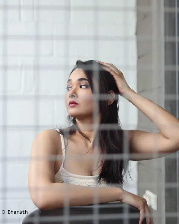A creative portrait shot through a wire mesh. This technique adds texture and an editorial feel to the image.