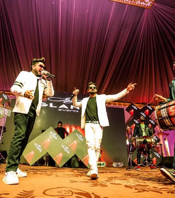 This shot perfectly captures our live dynamic. It shows our vocalist, dhol player, and me at the DJ console, all performing together to create that interactive musical experience we're known for.