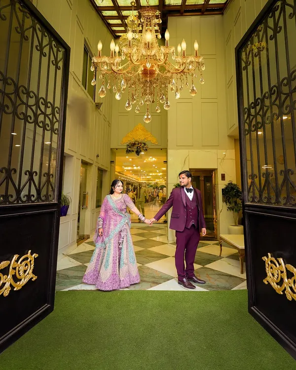 A grand entrance shot of the couple at their ring ceremony. The wide angle captures the beautiful venue and chandelier, making for a stunning photograph.