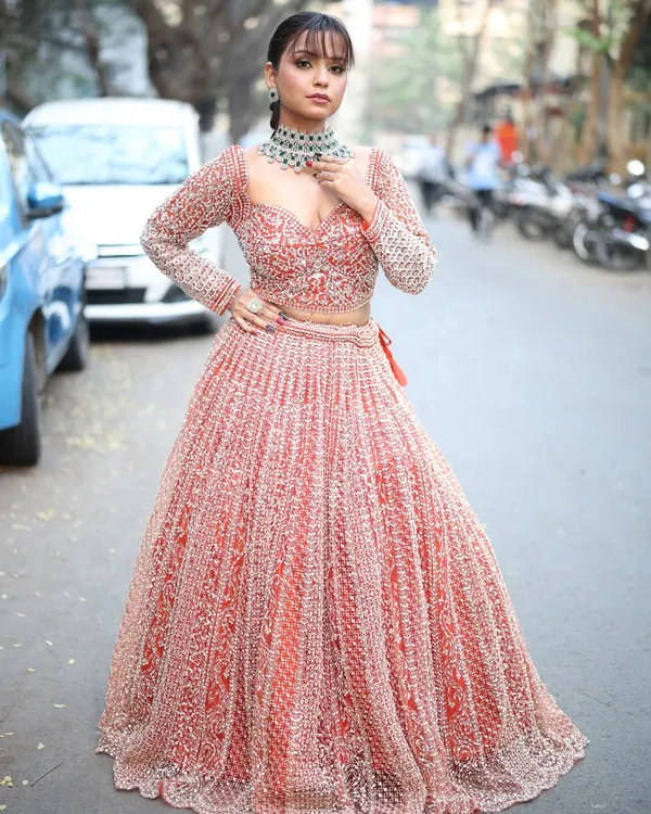 A full view of the gorgeous red and silver embroidered lehenga. The full-sleeve blouse and detailed skirt make it a truly regal choice for any bride or wedding guest.