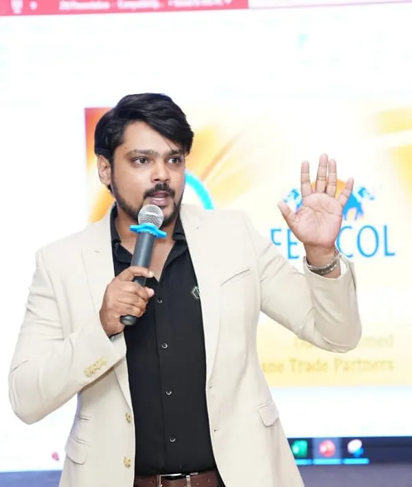 Addressing the audience at a Fevicol Dealers Meet. For brand events, I maintain a professional tone while ensuring the key messages are delivered with clarity and impact.