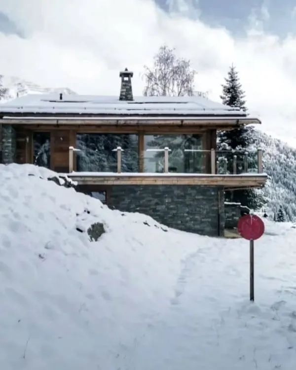 Our Swiss chalet project transformed by a blanket of snow. Designing for different seasons is key, and here the structure provides a warm, cozy refuge while still offering expansive views of the dramatic winter landscape.