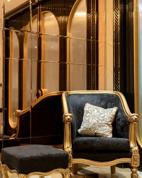 In this jewelry boutique, I used a bold combination of black velvet and gold-leafed frames for the seating. This pairing creates a sense of drama and opulence, inviting customers to sit and immerse themselves in the luxury experience.