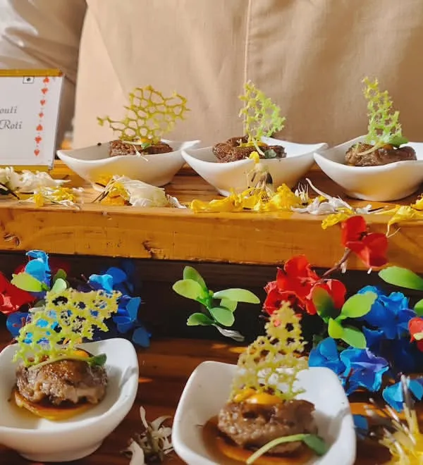 An example of our gourmet Indian appetizers. This dish features delicate Mushroom Galouti kebabs served on miniature Ulta Tawa Rotis, garnished with an intricate, crispy lattice for a touch of modern artistry.