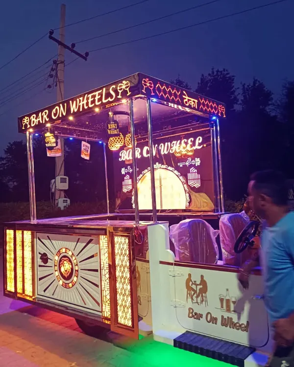 A side view of our 'Bar on Wheels' as it's being set up for an event. This mobile bar is a self-contained unit, allowing us to bring a complete, professional bar service to any location, no matter how remote.