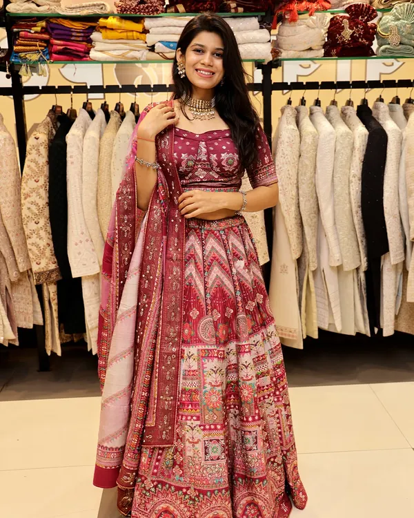 This maroon lehenga is a fantastic choice for a wedding or sangeet. The rich color and intricate, multi-patterned design create a look that is both traditional and eye-catching.