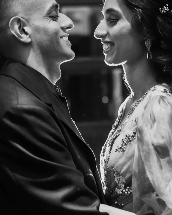 A perfect example of a cinematic black and white moment. The beautiful rim lighting outlines the couple's faces, creating an intimate and romantic portrait.
