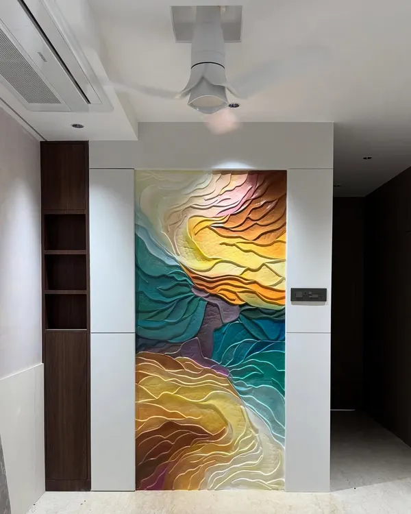 The abstract wave mural installed in a residential space. This full view shows how the artwork functions as a massive, colorful painting that completely transforms the wall.