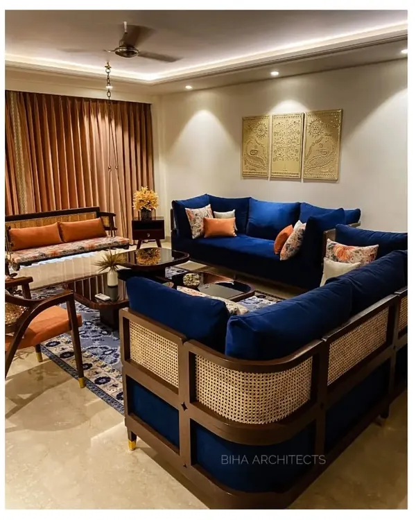 In this recently completed Gurgaon home, we used a rich royal blue velvet sofa with a cane-work frame as the centerpiece. This piece of bespoke furniture combines traditional craftsmanship with a modern silhouette, setting the tone for a space that is both elegant and unique.