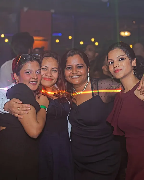 Spinning tracks and spreading joy. A happy group of friends enjoying the music and the atmosphere.