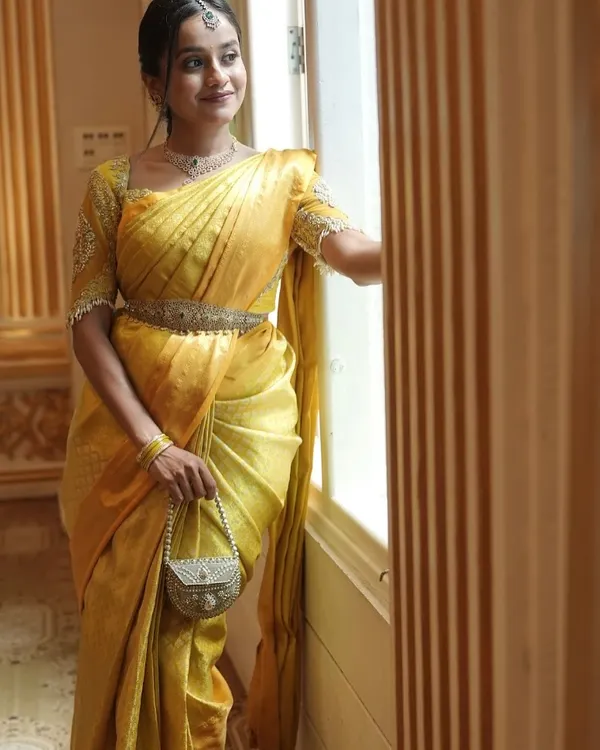 Dressed in a traditional yellow silk saree for a beautiful wedding ceremony. I love embracing traditional hues and elegant styles for daytime events.