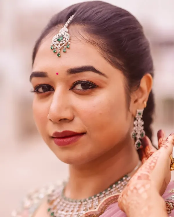 This close-up showcases my signature style: flawless, glowing skin that looks natural and fresh. I focused on defining the eyes with a classic liner and a beautiful berry lip color that enhances her features without feeling heavy.