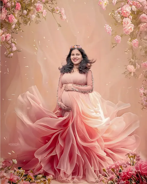 This is the fairytale moment every mother-to-be deserves. I use flowing fabrics, soft lighting, and floral arrangements to create truly magical maternity portraits like this one in my Kolhapur studio.