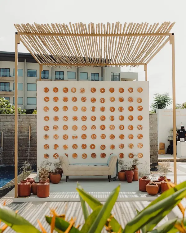 For this Champagne brunch, we created a photo backdrop using hand-painted pottery plates with Rangoli designs, surrounded by terracotta pots to evoke the feeling of a grandmother's courtyard.
