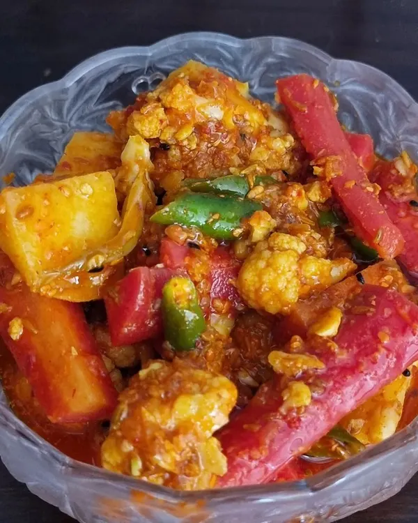 The famous winter special, Gajar Gobhi Shalgam achaar. It has a lovely khatta-meetha taste from the fresh carrots, cauliflower, and turnips mixed with jaggery and spices. It's a seasonal favorite that sells out fast.