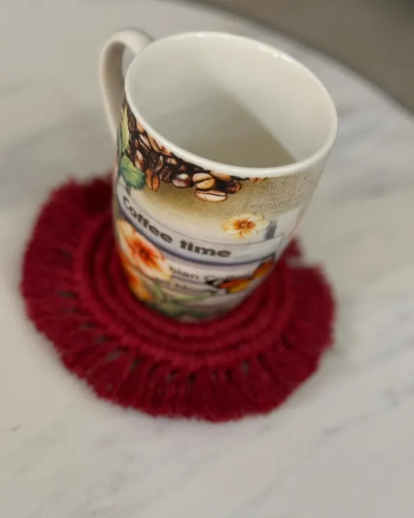 My macrame coasters are perfect for your daily cup of coffee or tea. This red fringed coaster adds a pop of color and protects your tabletop in style.