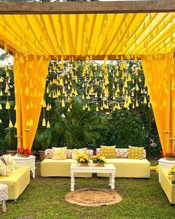 A classic and cheerful Haldi ceremony setup in a garden. We used bright yellow drapes, hanging marigold tassels, and comfortable seating to create a perfect, sun-kissed ambiance for this pre-wedding event.