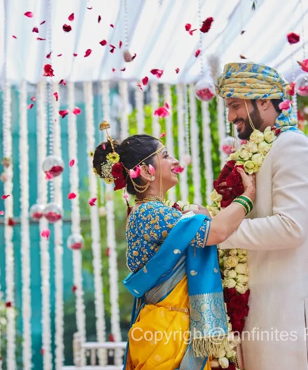 The Varmala (garland exchange) is one of the most photogenic moments of a wedding. I captured this shot as petals rained down, framing the couple in a shower of color and joy.