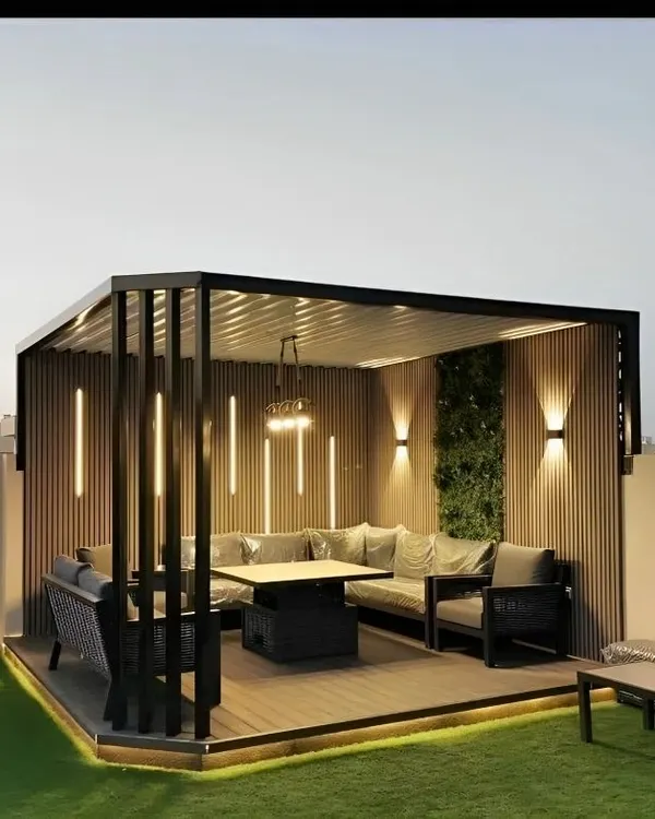This rooftop seating area was designed for evening entertaining and relaxation. We built a modern pergola with integrated vertical lighting and installed a large, comfortable sectional sofa. The design creates a cozy, room-like feel, making it a true extension of the home.