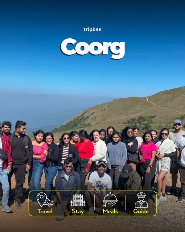 A happy group on our Coorg trip, with the rolling hills of the Western Ghats behind them. Our all inclusive packages cover travel, stay, meals, and a guide.
